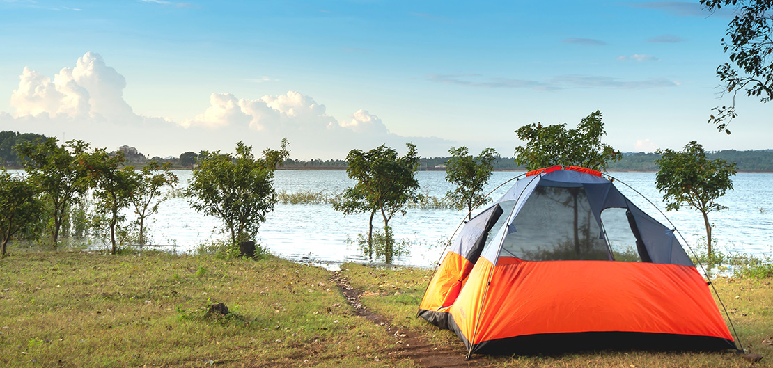 Image of tent by a lake